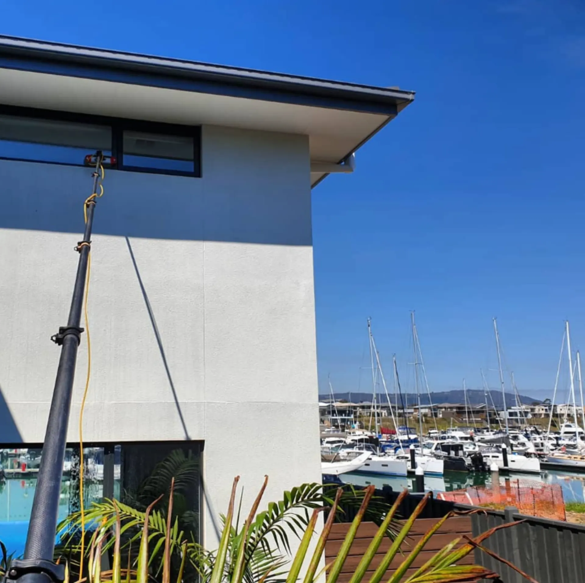 Clean home exterior overlooking marina with yachts